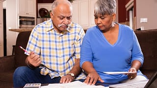 two people looking at documents bNJjmb