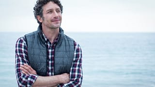 a person standing in front of a body of water gettyimages