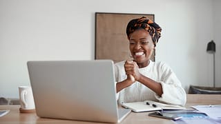 happy person looks at computer