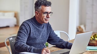 middle aged man notes laptopgettyimages
