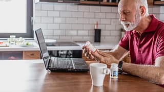 older man pills laptop gettyimages