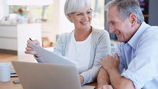 senior couple smiling laptop gettyimages