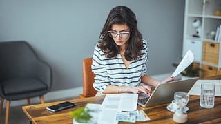 woman s laptop desk with documents