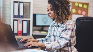 young person working on laptop