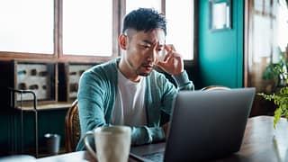 concerned unhappy person staring at laptop