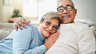 couple smiling on couch close together