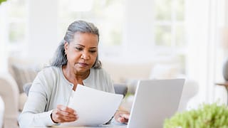 older woman document laptop gettyimages