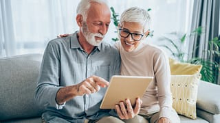 senior couple looking at tablet gettyimages