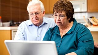 senior couple serious at laptop gettyimages