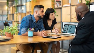 Couple meeting with banker in an office QDQ.width