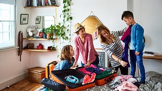 Family with kids packing for vacation qbaFuUl.width