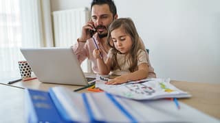 Father using laptop while on cell phone with .width rmjZiis