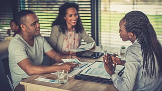 Financial professional talk to couple over pa.width vnBHhU