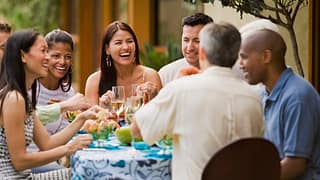 Group of friends dining on restaurant patio t.width