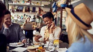 Group of friends enjoying food at a restauran.width vWjh
