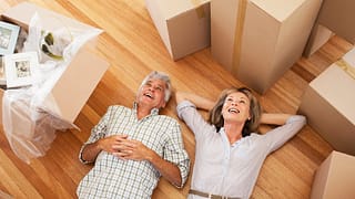 Happy mature couple laying on the floor surro.width rNWebku.jpg