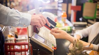 Man paying for groceries with credit card GEv.width