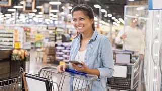 Smiling warehouse store club shopper with pho.width