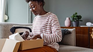 Woman packing up box to return item. juBzvHy.width
