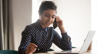 Woman with laptop on phone.width .jpg