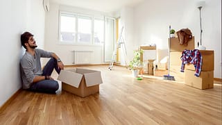 Young man empty apartment boxes imMTFem.width
