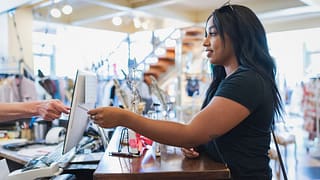 Young woman paying cashier with credit card i.width rIUHCo.jpg