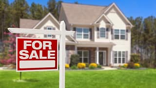 a house with a for sale sign in front gettyimages