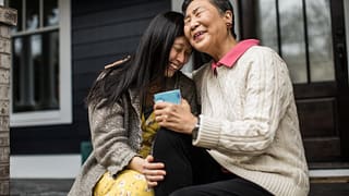 adult woman and senior mom seated hugging Syn.width .jpg