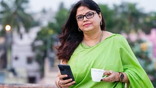 drinking tea and using her smartphone.jpg