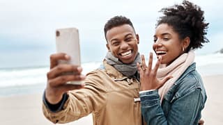engaged couple on beach.width