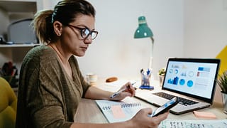 female investor reviewing her portfolio on a laptop