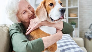 happy granny loving her dog in retirement