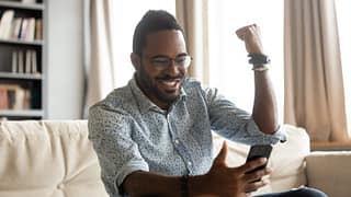 happy man with phone pumping fist dWwY.width