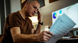 middle aged man serious looking at documents gettyimages