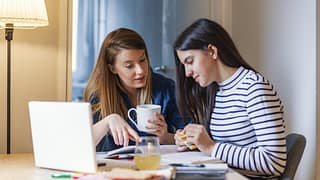 mom and teen daughter do homework ValSzh.width .jpg