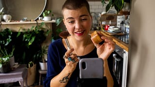 person holding makeup while recording on phon.width CHWzapr