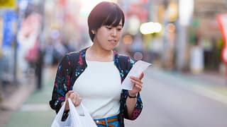 person with groceries and receipt NNaHY.width