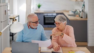 senior couple at a desk serious gettyimages