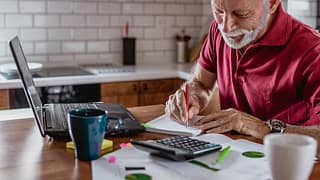 senior man is planning a home budget