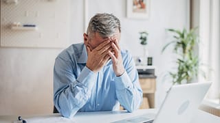 senior man laptop covering face gettyimages