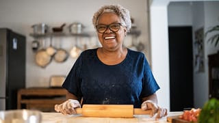 senior woman baking a smiling person holding a rolling pin gettyimages