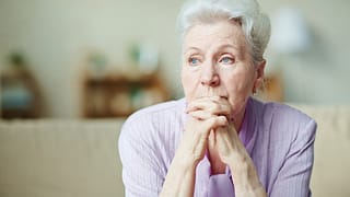 senior woman worried thinking with hands clasped in front of face.jpg