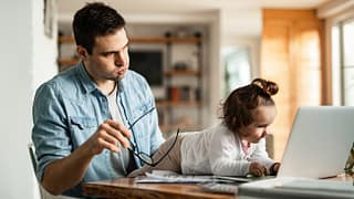 stressed dad working at home with baby.width