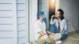 two people sitting on the floor and talking n.width IwLAY