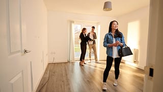 two people with realtor in empty house NVSf.width