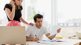two worried people at kitchen table with bill.width MIUbkr