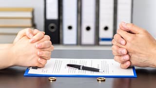 wife and husband signing for divorce.jpg