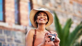 woman s smiling holding a camera gettyimages