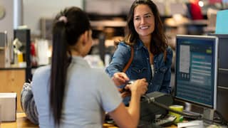 woman paying with credit card in department s.width tBfvJX