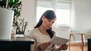 worried woman reading letter.width .jpg